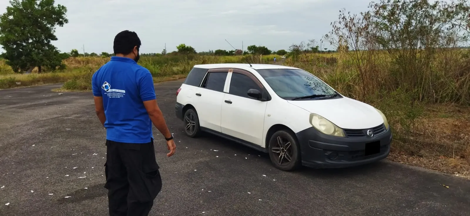 Gaffar GPS team member approaching a recovered vehicle at an active recovery site in Trinidad