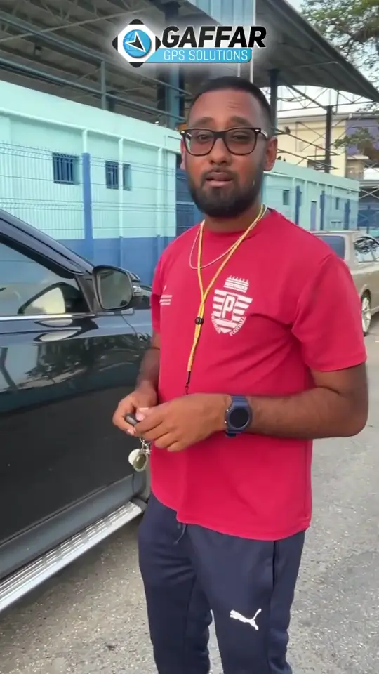 Coach Ali of Premier Sports Club beside his vehicle